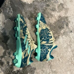 Blue beige and green adidas cleats
